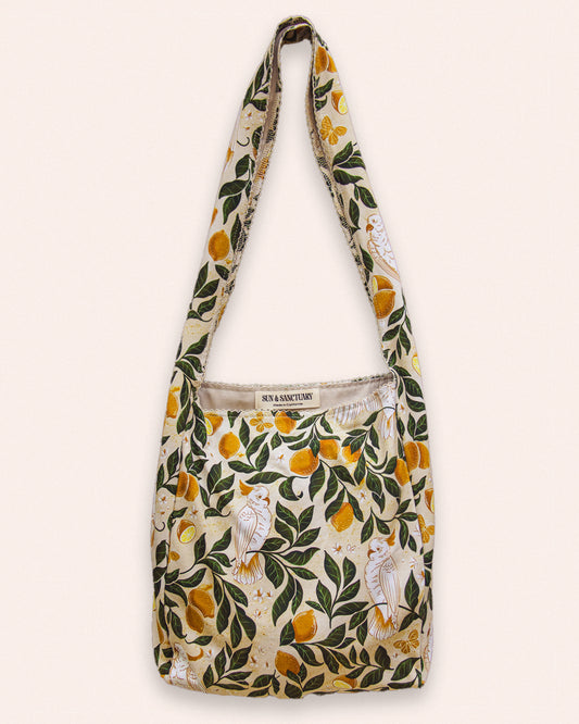 A boho style large hobo tote bag with a lemon, leaves, and cockatoo print.