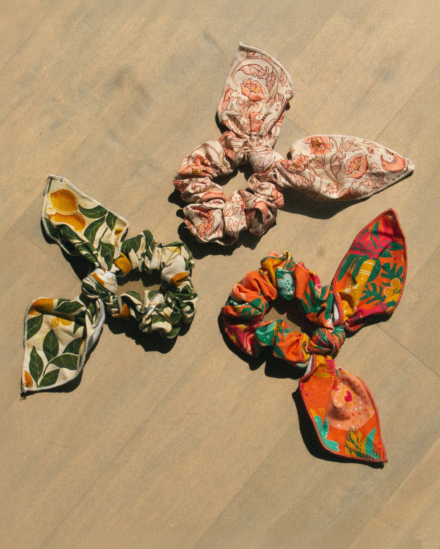 Three floral-patterned hair scrunchies for women's vintage inspired fashion. 