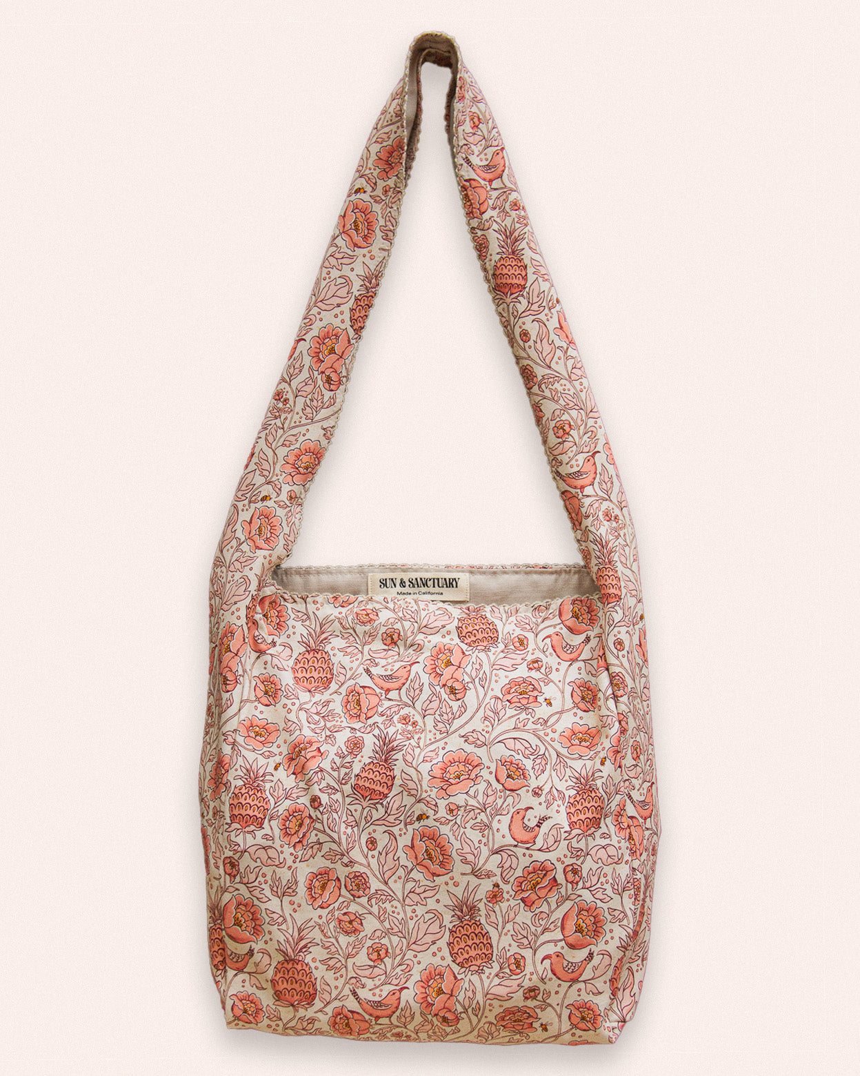 A pastel pink floral patterned slouchy tote bag for boho style. 