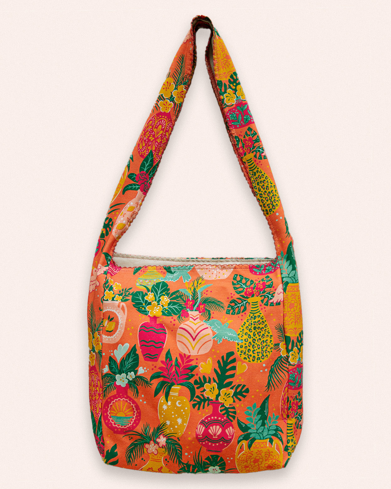 Colorful shoulder bag with tropical flower, bird, and palm leaves pattern.